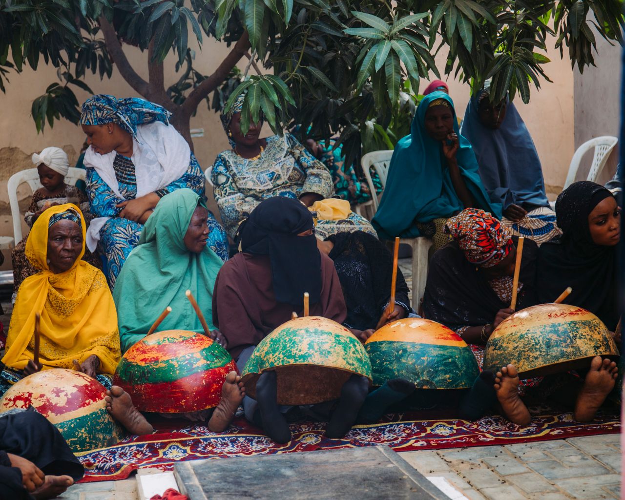 Women in traditional attire gather for a cultural event in Kano, Nigeria, showcasing community traditions.